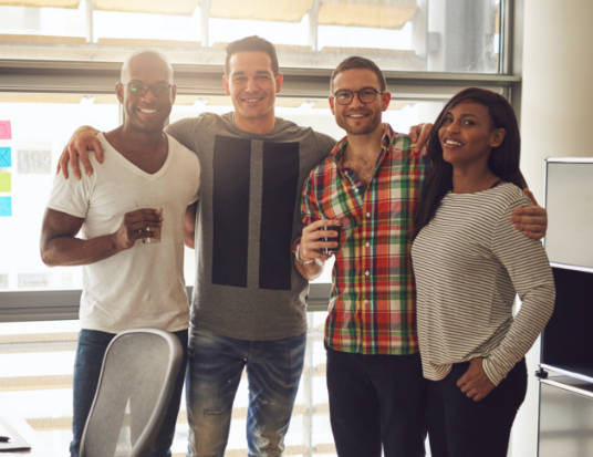 friends-smiling-and-standing-together-in-office